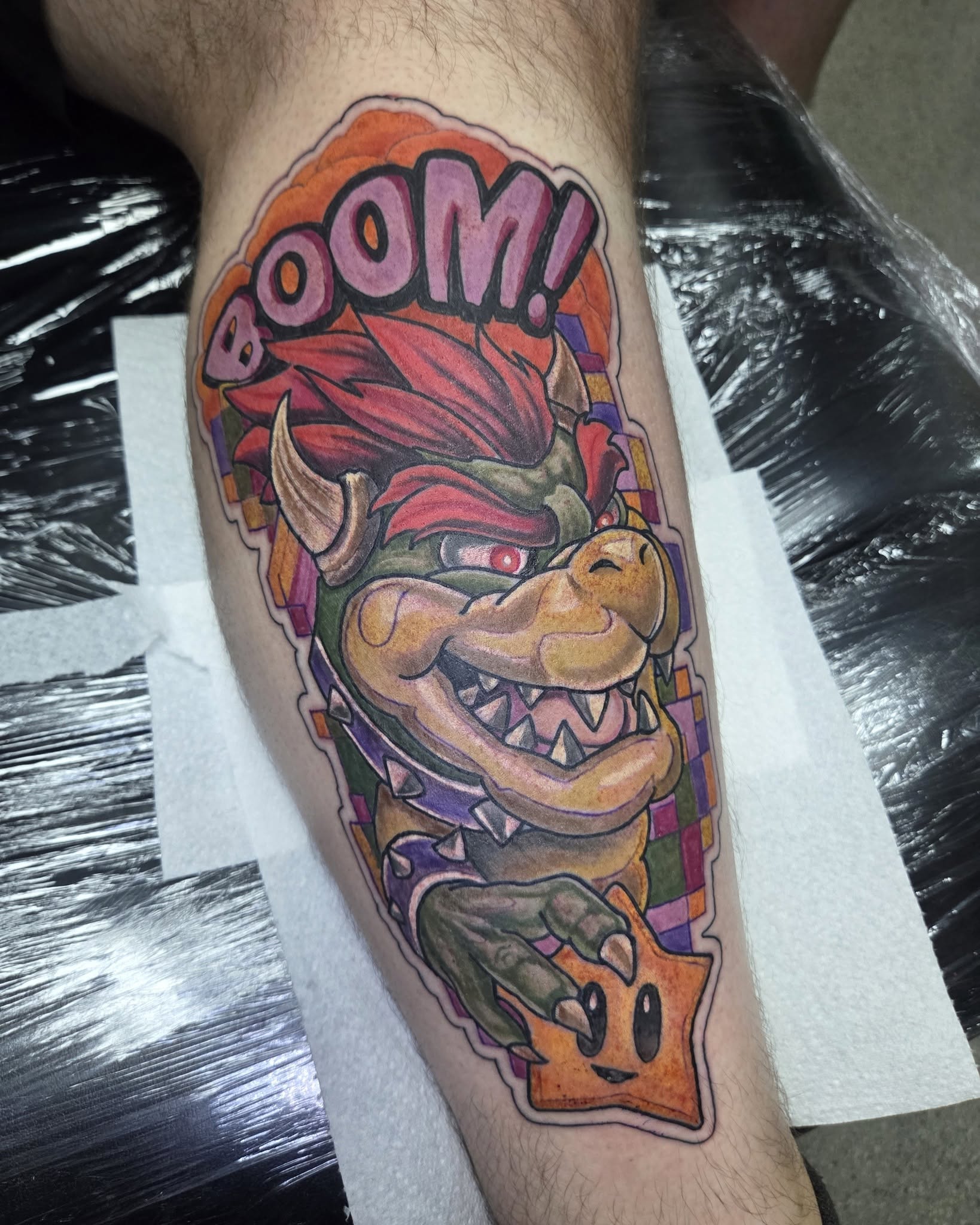 Dan’s full-colour Bowser tattoo with a BOOM speech bubble and orange flames