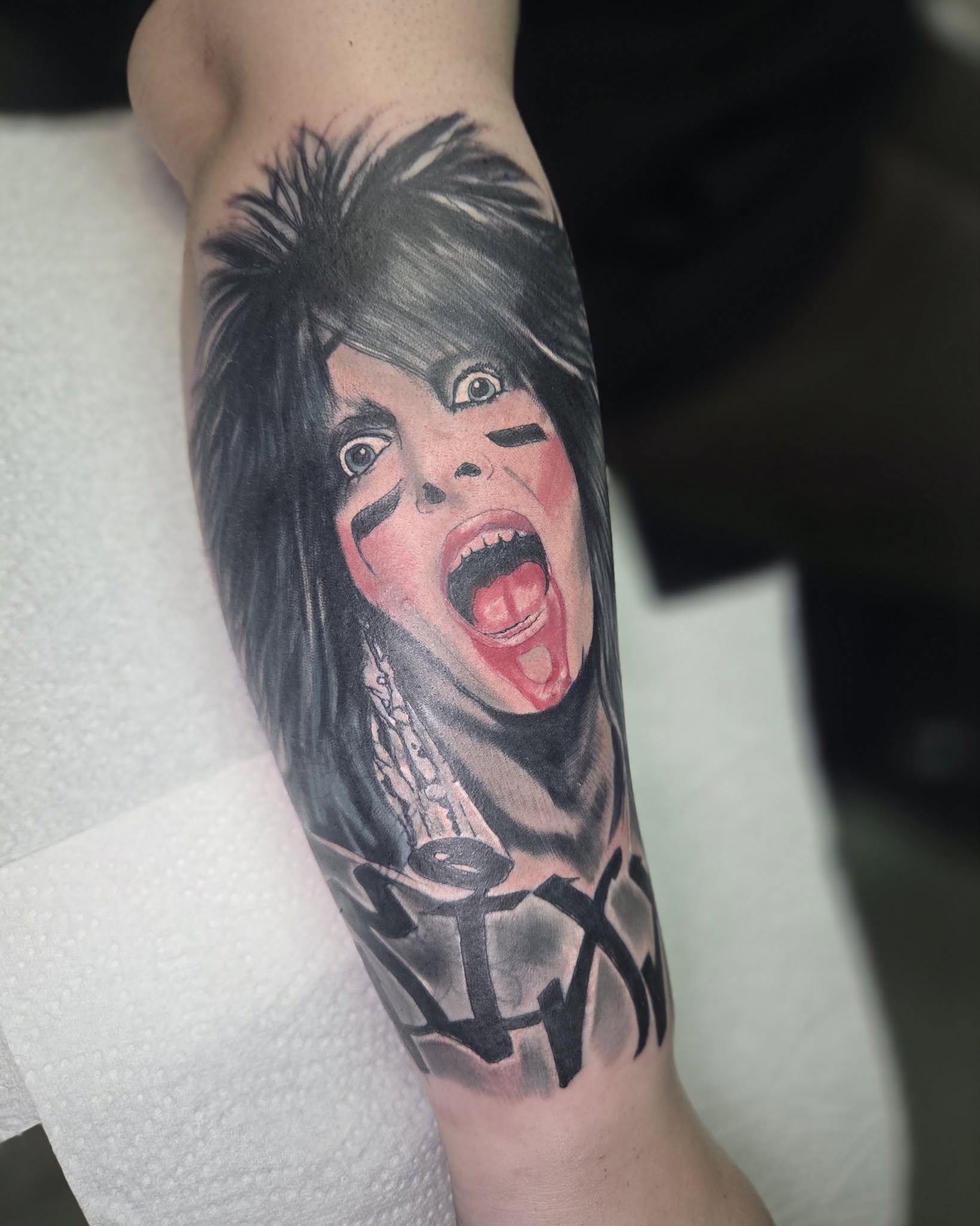 Dan’s expressive portrait tattoo with dark hair, face paint and pink skin tones